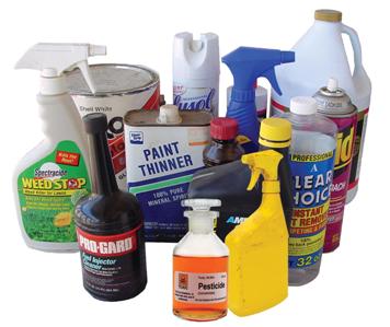 A collection of various household hazardous waste items, including bottles of weed killer, containers of paint thinner, and automotive chemicals.