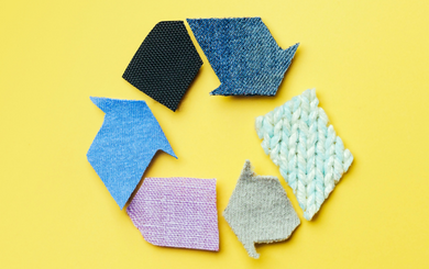 Recycling symbol made out of various textiles and fabrics.