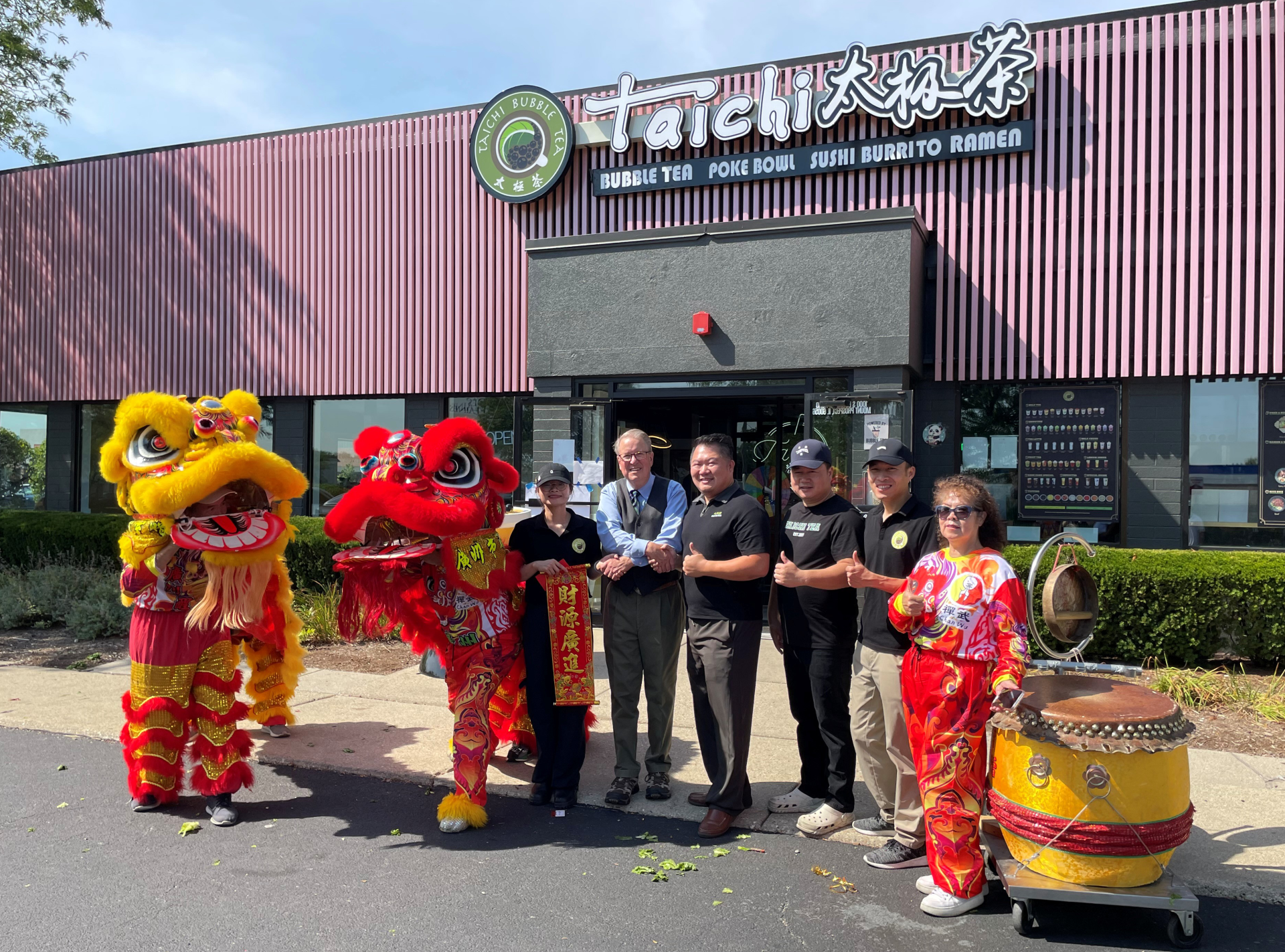 Mayor shaking hands with business owners at ribbon cutting event