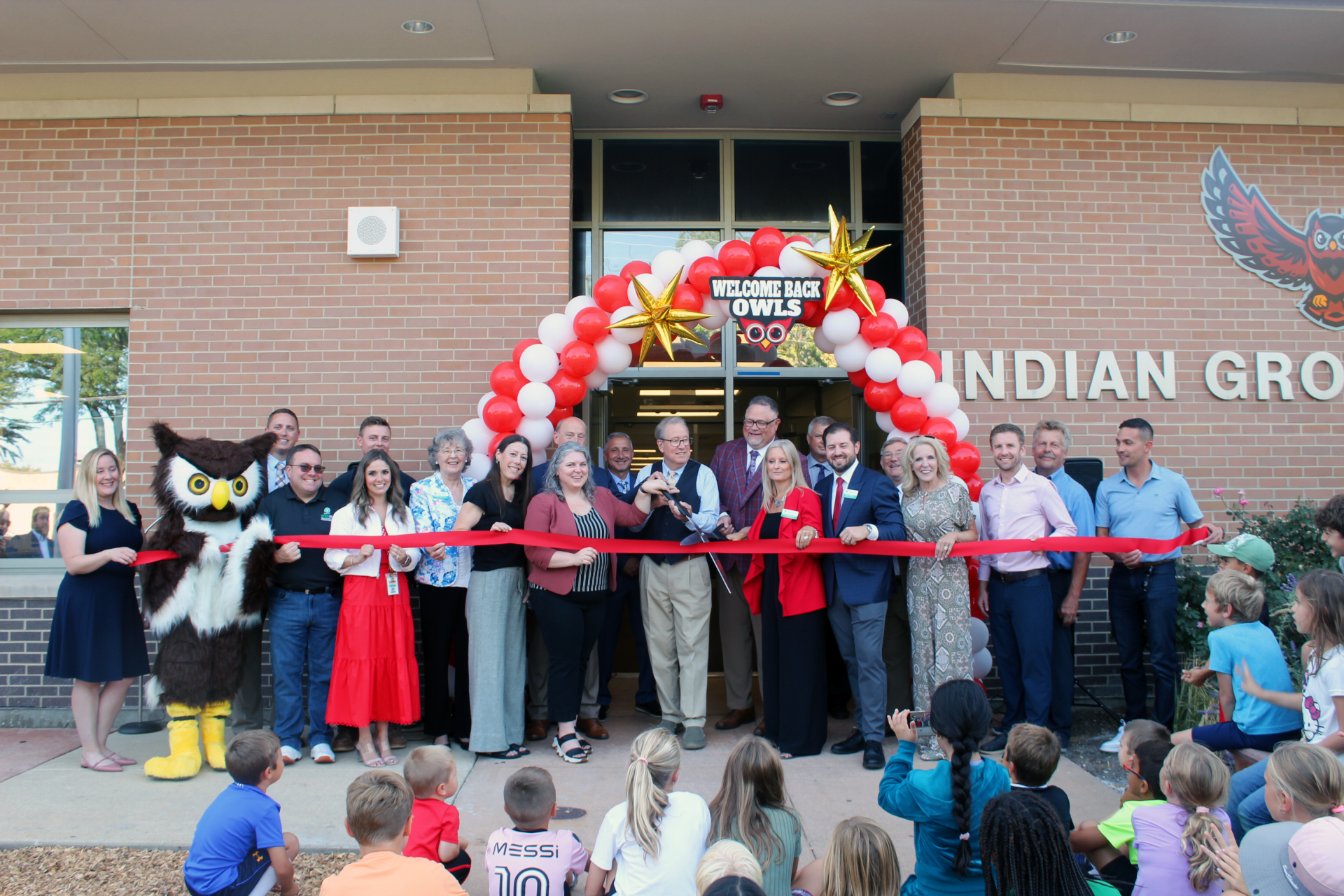 People at a ribbon cutting for Indian Grove School