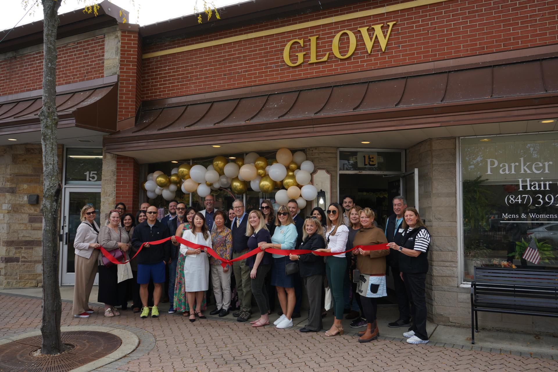 people holding ribbon in front of the glow place