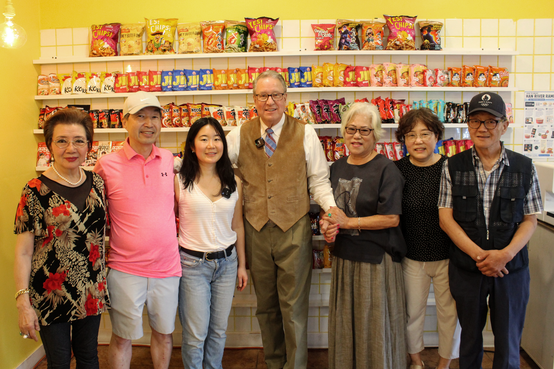 Business owner standing next to Mayor with family and friends surrounding